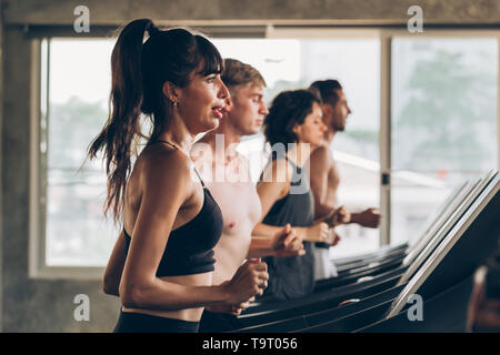 Junge 20 s Kaukasischen sportliche Gruppe von Männern und Frauen zusammen, die auf Laufband im Fitnessstudio - Taille nach oben geschossen - Fitness Sport portrait Stockfoto