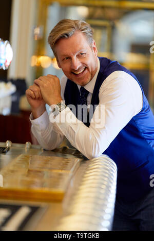 Mann an der Bar lächelnd Stockfoto