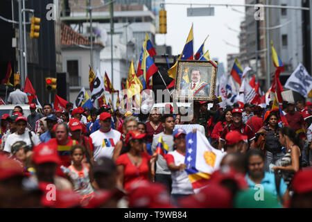 Caracas, Venezuela. 20 Mai, 2019. Anhänger der venezolanische Präsident Maduro tragen ein Bild von der Staatschef auf einer Kundgebung anlässlich des Jahrestages seiner Wiederwahl. Maduro übernahm den Vorsitz von Venezuela im Jahr 2013 nach dem Tod von Chavez. Er wurde am 20. Mai 2018 gewählt. Aber seit seiner Wiederwahl soll nicht zu demokratischen Prinzipien verwandelt zu haben, viele Länder nicht mehr Maduro erkennen. Credit: Pedro Mattey/dpa/Alamy leben Nachrichten Stockfoto