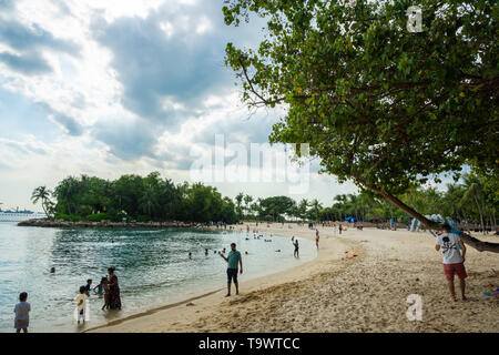 Singapur - Januar 2019: Menschen bei Siloso Beach auf Sentosa Island in Singapur. Es ist ein künstlicher Strand mit Sand aus Malaysia genommen Stockfoto