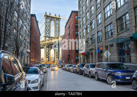 Blick auf Manhattan Bridge bilden einen engen, gepflasterten Straße in Brooklyn bei Sonnenuntergang im Winter. Stockfoto