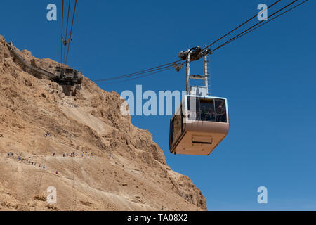 Israel, historischen Masada aka Massada. Seilbahn auf den Gipfel des Masada. Touristen wandern bis zum Gipfel auf der Schlange Weg in der Ferne. Stockfoto