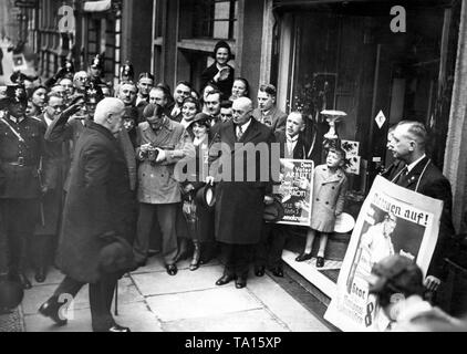 Präsident Paul von Hindenburg und Staatssekretär Otto Meissner auf dem Weg zum Wahllokal anlässlich des Preußischen Landtags Wahlen. Anhänger der einzelnen Parteien stehen mit wahlplakate vor dem Wahllokal. Stockfoto