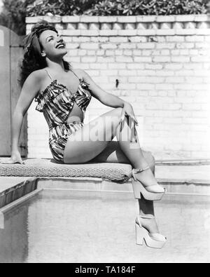 CARMEN MIRANDA ca. 1942 in voller Länge Pin-Up Pose im Badeanzug auf Schwimmbad Sprungturm Twentieth Century Fox Stockfoto