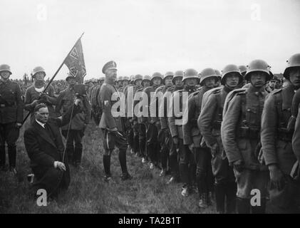 Wilhelm, Deutscher Kronprinz (Mitte) steht vor dem Feld Standard, das er dem Jungstahlhelm (junge stahlhelm) Regiment' Kronprinz von Preussen' ('Kronprinz von Preußen'), während einer März der Stahlhelm in Wittenberg (Prignitz) dotiert. Auf der rechten Seite, ein Unternehmen der Jungstahlhelm im Feld Anlagen. Stockfoto