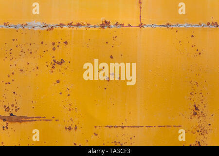 Verrostete gelben Bus flach Hintergrund closeup mit Flecken Stockfoto