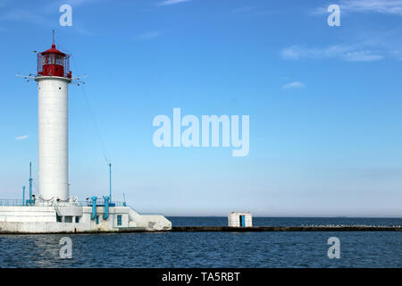 Rot-weiße Leuchtturm gegen den blauen Himmel und Meer Stockfoto