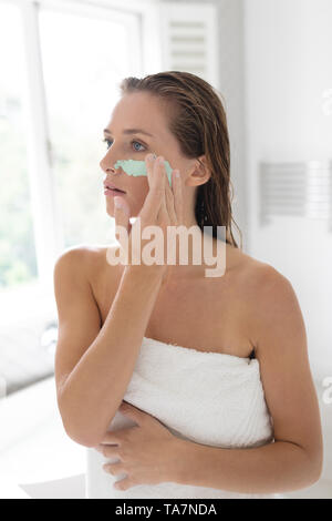 Frau mit Gesichtsmaske nach Badewanne Stockfoto