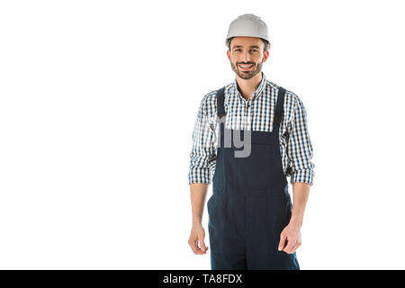 Lächelnd Bauarbeiter in Overall und Helm an Kamera isoliert auf weißem suchen Stockfoto