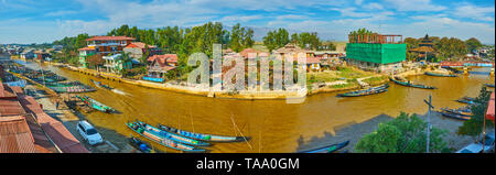 NYAUNGSHWE, MYANMAR - 19. FEBRUAR 2018: Panorama der schmalen langen Kanal der Inle See mit Kayak-port, kleine Häuser und Hotels auf ihren Banken, Stockfoto