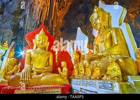 PINDAYA, MYANMAR - 19. FEBRUAR 2018: Die malerische Buddha Bilder in Pindaya Cave sind mit Vergoldung, Relief Muster, ornamentalen Textil- und Pa eingerichtet Stockfoto