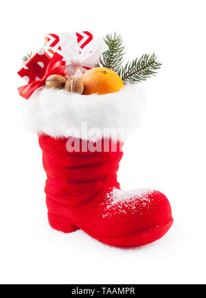 Santa Claus Stiefel gefüllt mit Süßigkeiten und Geschenke Stockfoto