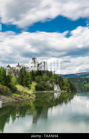 Niedzica Burg auf dem Hügel, lond Exposition Bewegungsunschärfe am See Czorsztyn und Wolken am Himmel. Stockfoto