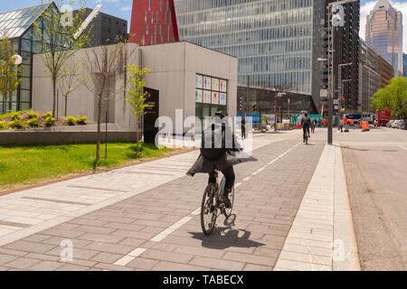 Montreal, Kanada - 21. Mai 2019: Eine Frau mit dem Fahrrad auf einem Radweg, der auf De Maisonneuve Boulevard. Stockfoto