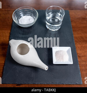 Für nasale Reinigung mit neti Pot, ayurvedische Medizin System, rosa Salz, Natron, Wasser auf einer Schiefertafel eingestellt Stockfoto