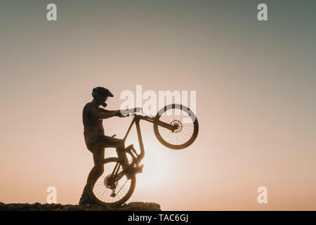 Spanien, Lanzarote, Mountainbiker auf einer Reise bei Sonnenuntergang Stockfoto