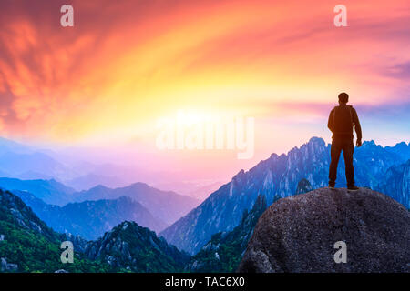 Junge glücklich Backpacker auf einem Berg mit Blick auf das Tal Stockfoto