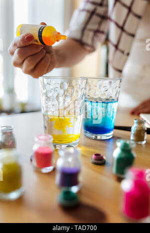 Maler Füllflüssigkeit Farbe ins Glas Wasser, Teilansicht Stockfoto
