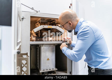 Mann hält Spiegel examimning 3d-Drucker Stockfoto