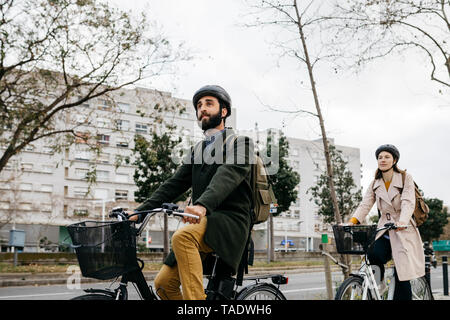 Paar Reiten e-bikes in der Stadt Stockfoto