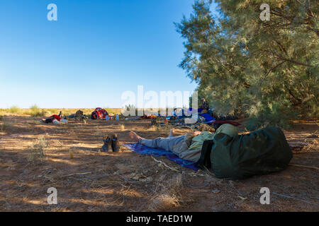 Errachidia Provinz, Marokko - Oktober 15, 2015: Travelers Rest in den Schatten der Bäume nach der Reise durch die Wüste Sahara. Oasis. Im mi Rest Stockfoto