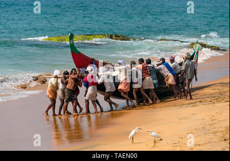 Horizontale Ansicht der lokalen Fischer ihr Boot Start heraus zum Meer in Kerala, Indien. Stockfoto