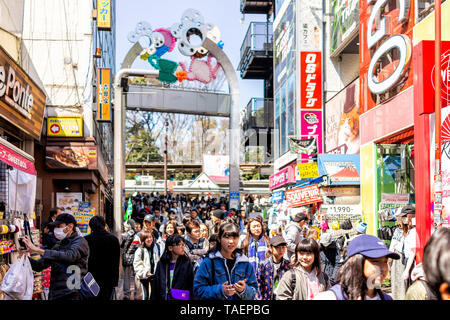 Tokio, Japan - April 2, 2019: Berühmte Takeshita Straße in Harajuku mit Masse von vielen Menschen zu Fuß durch farbenfrohe Gebäude Stockfoto