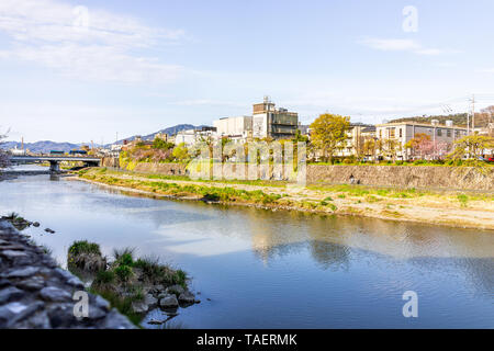 Kyoto, Japan - 9. April 2019: Fluss Kamo Wasser im Sonnenuntergang am Abend mit stadtbild Skyline von Gebäuden am Ufer des Canal Stockfoto