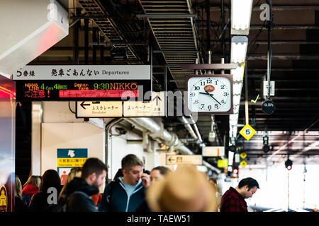 Tokio, Japan - April 4, 2019: Bahnhof Plattform lokale Linie nach Nikko unterzeichnen und überdachte Architektur mit vielen Menschen die Warten, von Titel und Clo Stockfoto