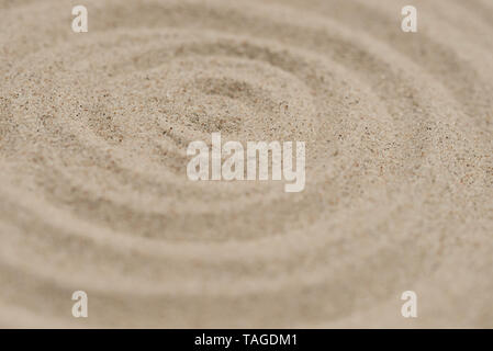 Konzentrische Kreise Muster auf natürlicher Sand Textur Hintergrund closeup Stockfoto