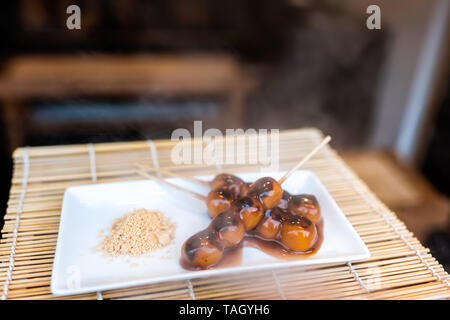 Anzeige der dampfenden Mochi dango Snack mit Reis Kuchen und Miso Sojasauce Sirup auf Bambus traditionelle japanische Street Food Stockfoto