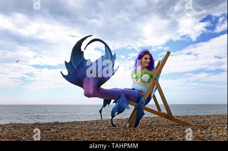 Mermaid Jasz Vegas Posen am Strand während das wechselhafte Wetter in Brighton als Sea Life Brighton die Öffnung ihrer Tag/Nacht erleben. Stockfoto