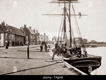 Ein Ende des 19. Jahrhunderts der Musikant, ein Segelschiff im Hafen von Wells-next-the-Sea, aka Wells, ein Hafen an der Küste von North Norfolk in England. Die Stadt begann, als Brunnen bekannt sein-next-the-Sea im frühen 19. Jahrhundert zur Unterscheidung von anderen Orten mit gleichem Namen. Wenn die Brunnen und Fakenham Bahn wurde am 1. Dezember 1857 eröffnete, die Endstation der Name 'Brunnen-auf-See". 1956 Die Brunnen Urban District Council (wieder) zu den Namen Brunnen - Verabschiedung next-the-Sea, und dieser hat den offiziellen Namen seitdem gestimmt. Stockfoto