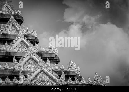 Closeup Detail der Tempel in Thailand. Kunst Muster. Traditionelle Thai Stil Skulptur gegen Wolken und Himmel. Schwarz und Weiß, Szene der Tempel detail. Ba Stockfoto