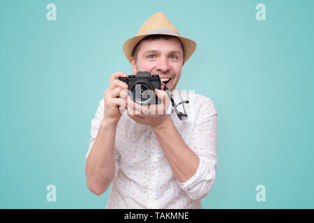 Junge touristische Mann unter Foto mit dslr bei Camera suchen Stockfoto