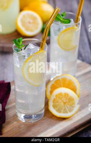 Zwei Gläser refeshing Limonade mit Zitronenscheiben auf einem Holzbrett Stockfoto