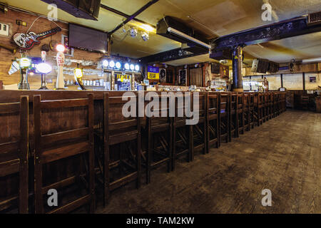 Kiew, Ukraine - 19. März 2018. Holzstühlen mit hohen Rückenlehnen an der Bar stehen in einer Reihe in einem Pub. Stockfoto