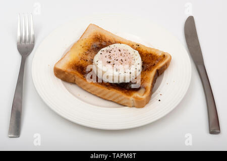 Pouched Ei auf Toast mit Gecrackten schwarzer Pfeffer Stockfoto