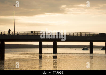 Ein Mann stand auf der Brücke an Ferry Bridge am Abend im Mai. Ferry Bridge ist mit dem Start der Damm, auf der Isle of Portland in den Ableitungen Stockfoto