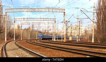 Blick auf die beweglichen Bahn Personenzug in Blau vor dem Hintergrund des Stadtbildes Stockfoto