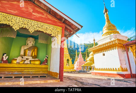 Der Schrein mit verzierten Statue von Buddha unter Die stupas von Nget Pyaw Taw Paya, Pindaya, Myanmar. Stockfoto