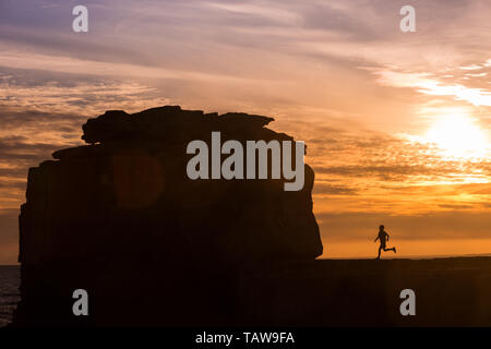 Portland, Dorset, Großbritannien. 28 Mai, 2019. Nach einem kühlen und wechselhaften Tag Wetter, ein Junge ist gegen den Abendhimmel von Pulpit Rock on Portland Bill, Dorset. Kanzel Rock hat eine beliebte Touristenattraktion auf der Insel geworden und wird oft Peter Lopeman/Alamy Leben Nachrichten fotografiert. Stockfoto