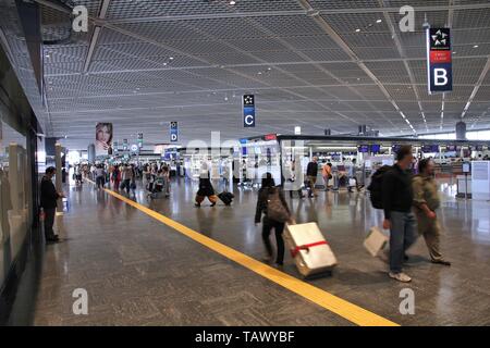 TOKYO, Japan - 12. MAI 2012: Reisende beeilen im Internationalen Flughafen Narita, Tokio. Narita war der 2 verkehrsreichsten Flughafen in Japan und 50 verkehrsreichsten worl Stockfoto