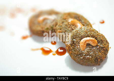 Hohen winkel Nahaufnahme eines grünes Gemüse Schnitzel mit unordentlichen Tomatensauce auf weiße Platte. Stockfoto