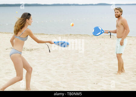 Paar ein Spiel spielen am Strand Stockfoto