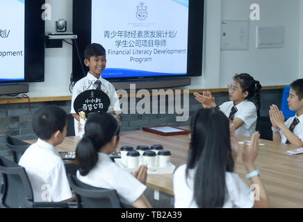 (190530) - Peking, 30. Mai 2019 (Xinhua) - Thuch Salik teilt seine kommerzielle Erfahrung mit Mitschülern an einer ausländischen Sprachschule in Zhuji, der ostchinesischen Provinz Zhejiang, 29. Mai 2019. Thuch Salik wurde virale über Nacht, wenn ein Video Clip zeigt ihn mit Souvenirs in einem Dutzend Sprachen in der Nähe von Angkor Wat auf November 2018 online geteilt wurde. In einer Familie, die mit finanziellen Schwierigkeiten geboren, die 14-jährige Kambodschanischen Junge erhielt weltweite Aufmerksamkeit für seine mehrsprachige Talent. Im Mai, Salik war ein Ort an einer ausländischen Sprachschule in Zhuji der ostchinesischen Provinz Zhejiang angeboten auf einer Stockfoto