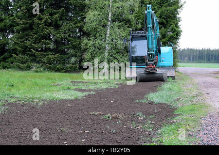 Kleine Bagger in Garten- und Landschaftsbau zu tun. Stockfoto