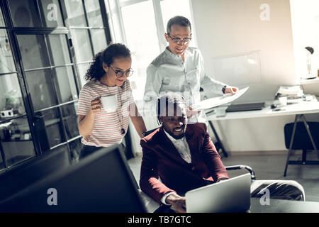 Unternehmen von Freiberuflern lächelnd, während arbeiten zusammen Stockfoto