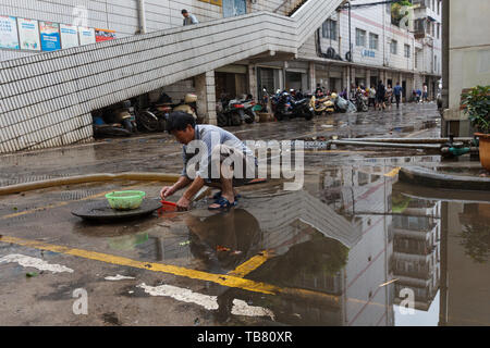 Kunming - 20. Juli 2017 - Bürger aufräumen Gemeinschaft nach starken Regenfällen Stockfoto