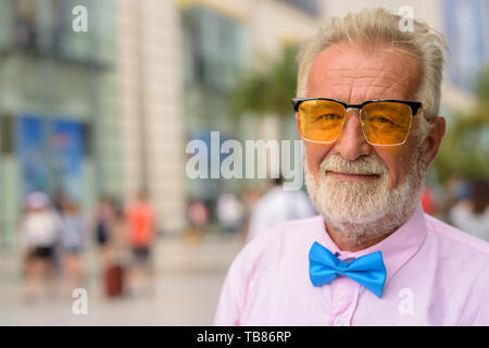 Portrait von Stattlichen senior touristische Mann, stilvolle Kleidung, während die Stadt von Bangkok, Thailand erkunden Stockfoto